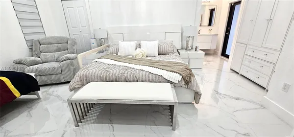 a bedroom with a bed and a couch