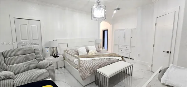 a bedroom with furniture and a chandelier