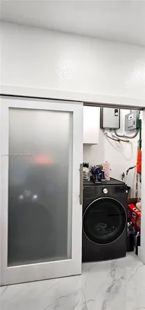 a bathroom with a sink and a washing machine