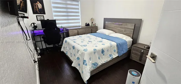 a bed sitting in a bedroom next to a window