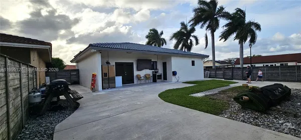 a view of a house with backyard and entertaining space