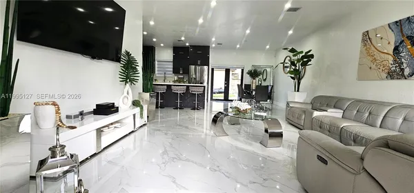 a living room with furniture and a flat screen tv