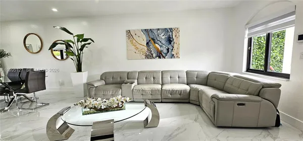 a living room with furniture and window