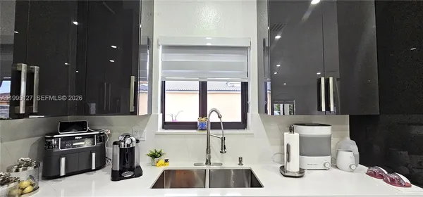 a kitchen with stainless steel appliances a sink a stove and a refrigerator