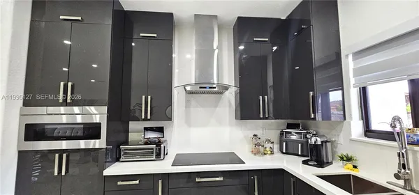 a kitchen with a sink and refrigerator