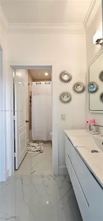 a bathroom with a sink a vanity and a shower