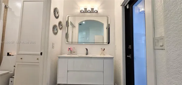 a bathroom with a sink and a mirror