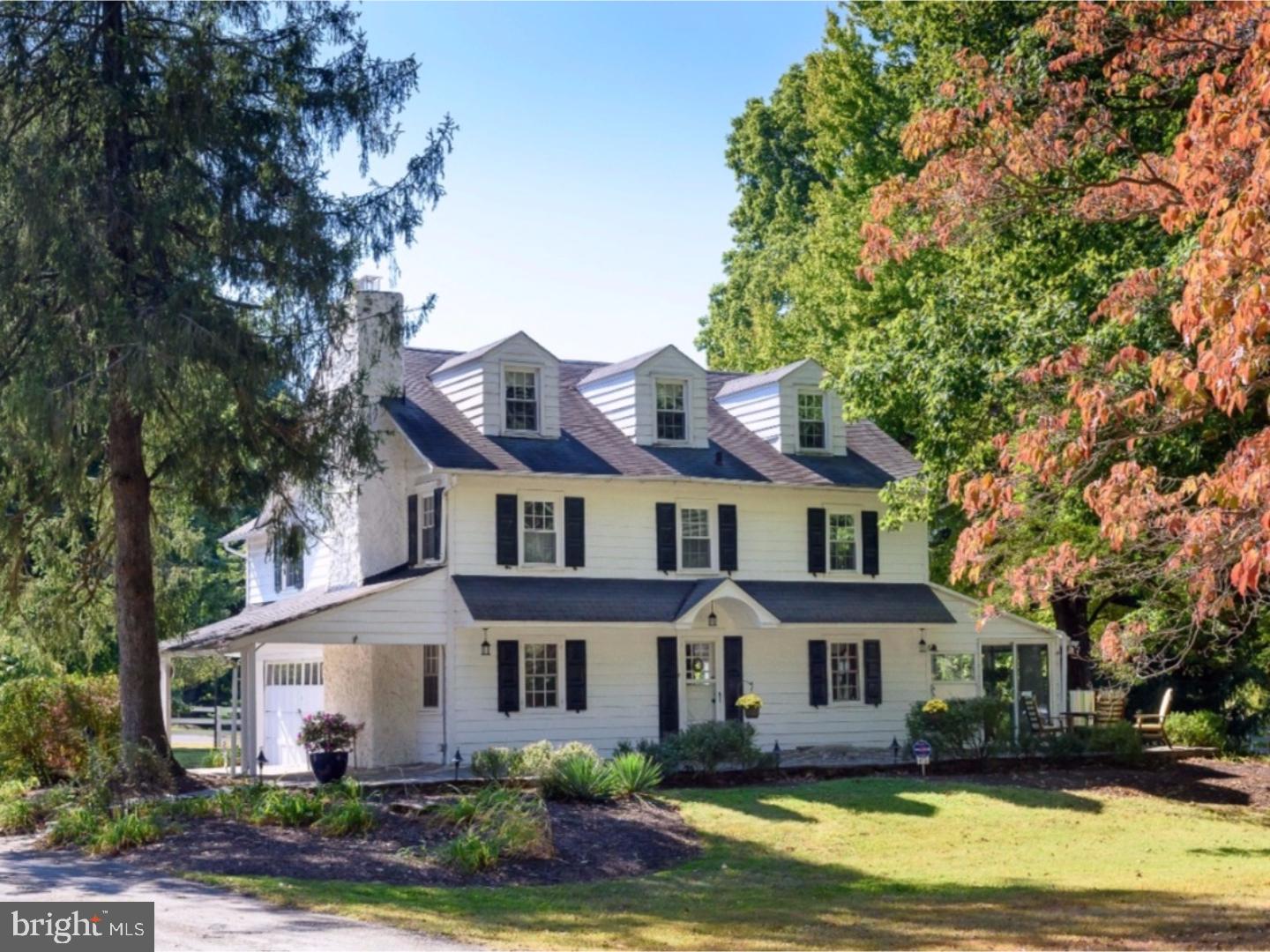 500 Gulph Road Wayne, PA 19087 - Photo 1 of 25 a front view of a house with a garden and trees