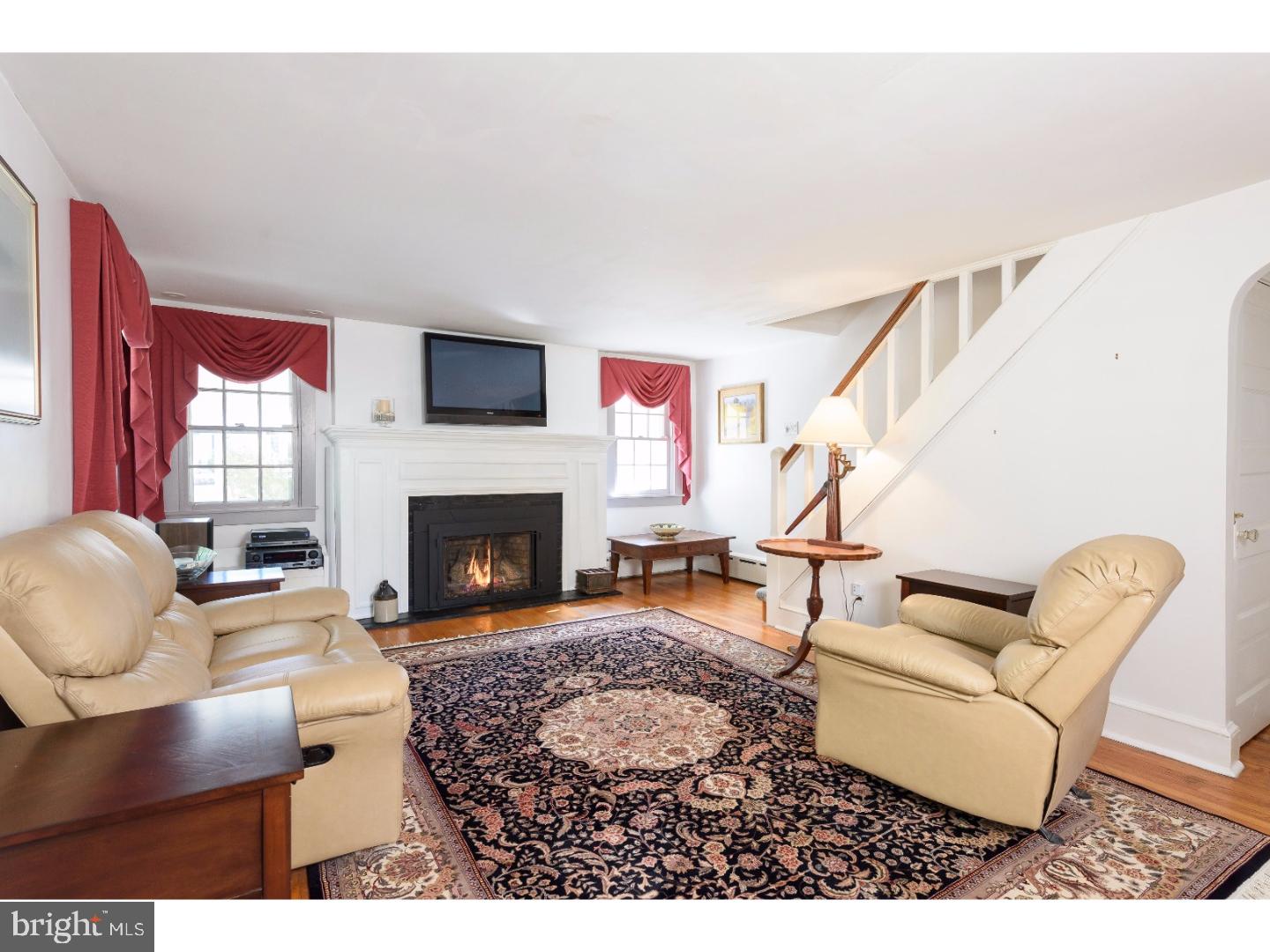 500 Gulph Road Wayne, PA 19087 - Photo 4 of 25 a living room with furniture a flat screen tv and a fireplace
