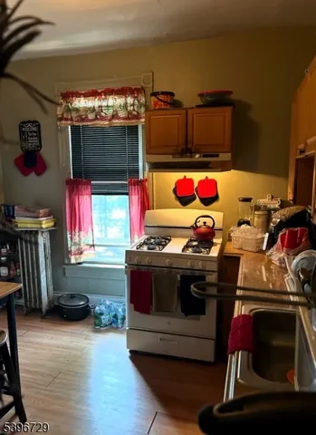 a kitchen with stainless steel appliances granite countertop a stove and a microwave