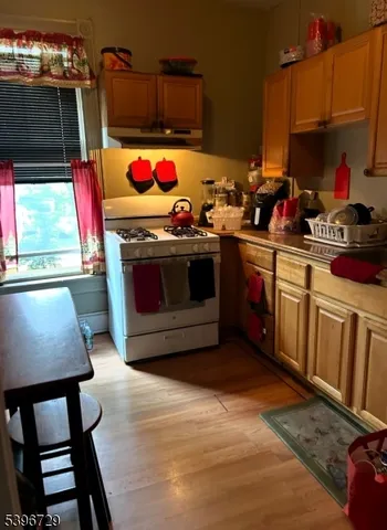 a kitchen with stainless steel appliances kitchen island granite countertop a stove a sink and a microwave