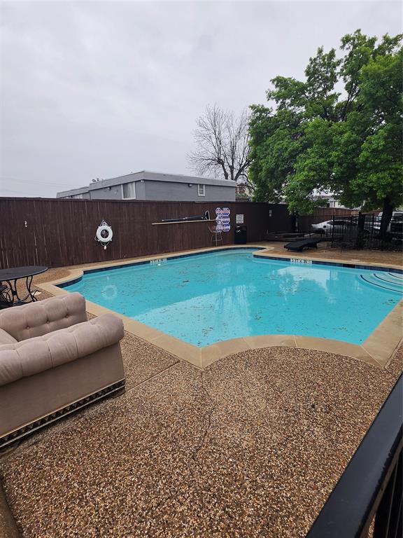 13219 Emily Road, Unit 4104 Dallas, TX 75240 - Photo 6 of 7 The property features an outdoor swimming pool with a surrounding exposed aggregate concrete deck and a light-colored coping