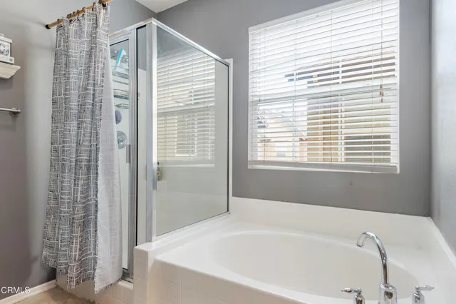 a bathroom with a bathtub and a shower