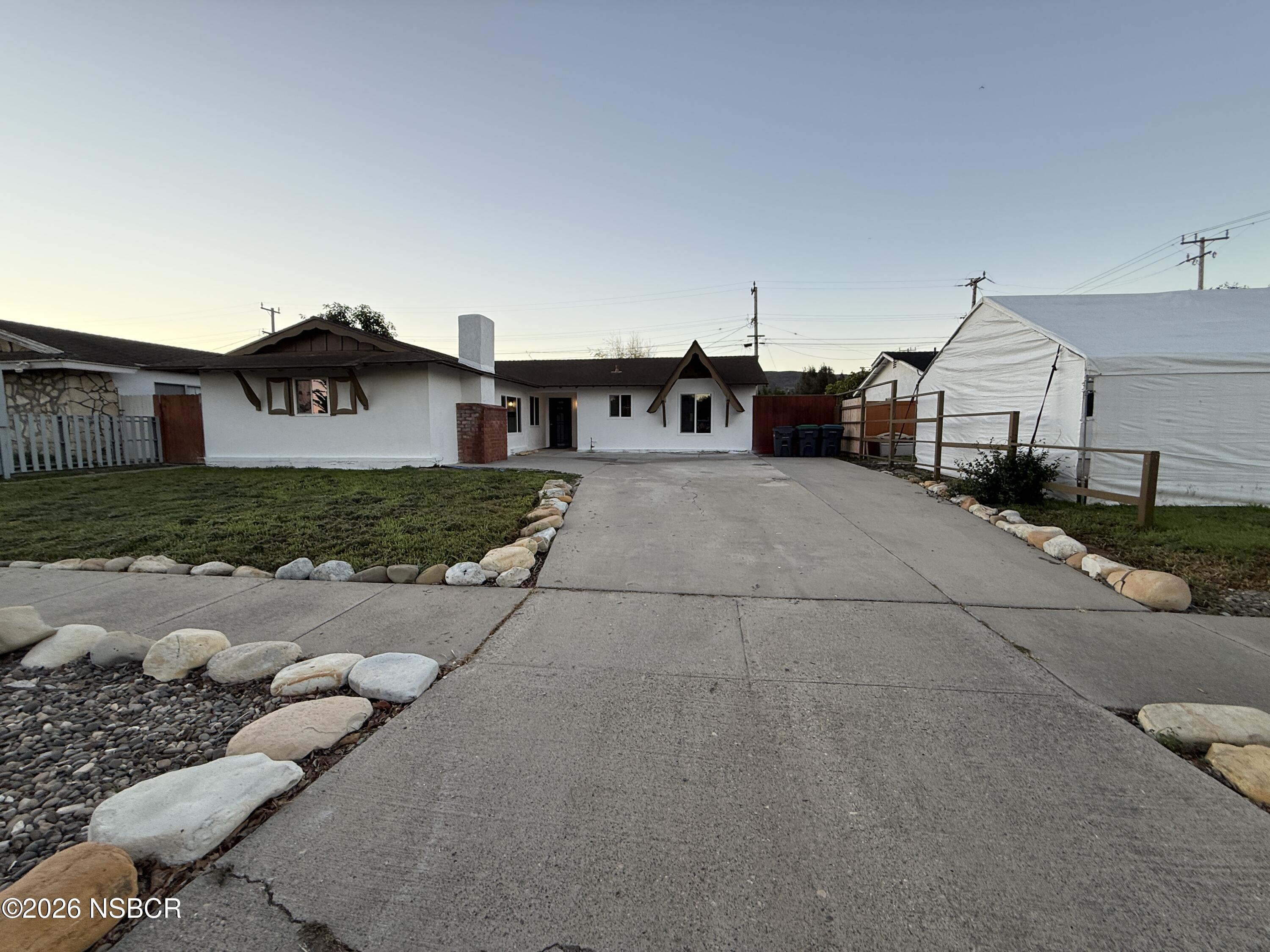 1408 West Walnut Avenue Lompoc, CA 93436 - Photo 1 of 27 a view of a house with a yard