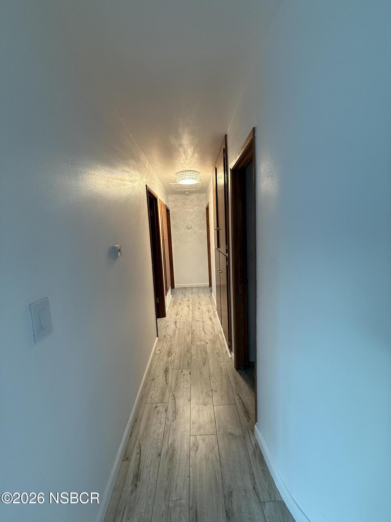 1408 West Walnut Avenue Lompoc, CA 93436 - Photo 12 of 27 a view of hallway with wooden floor