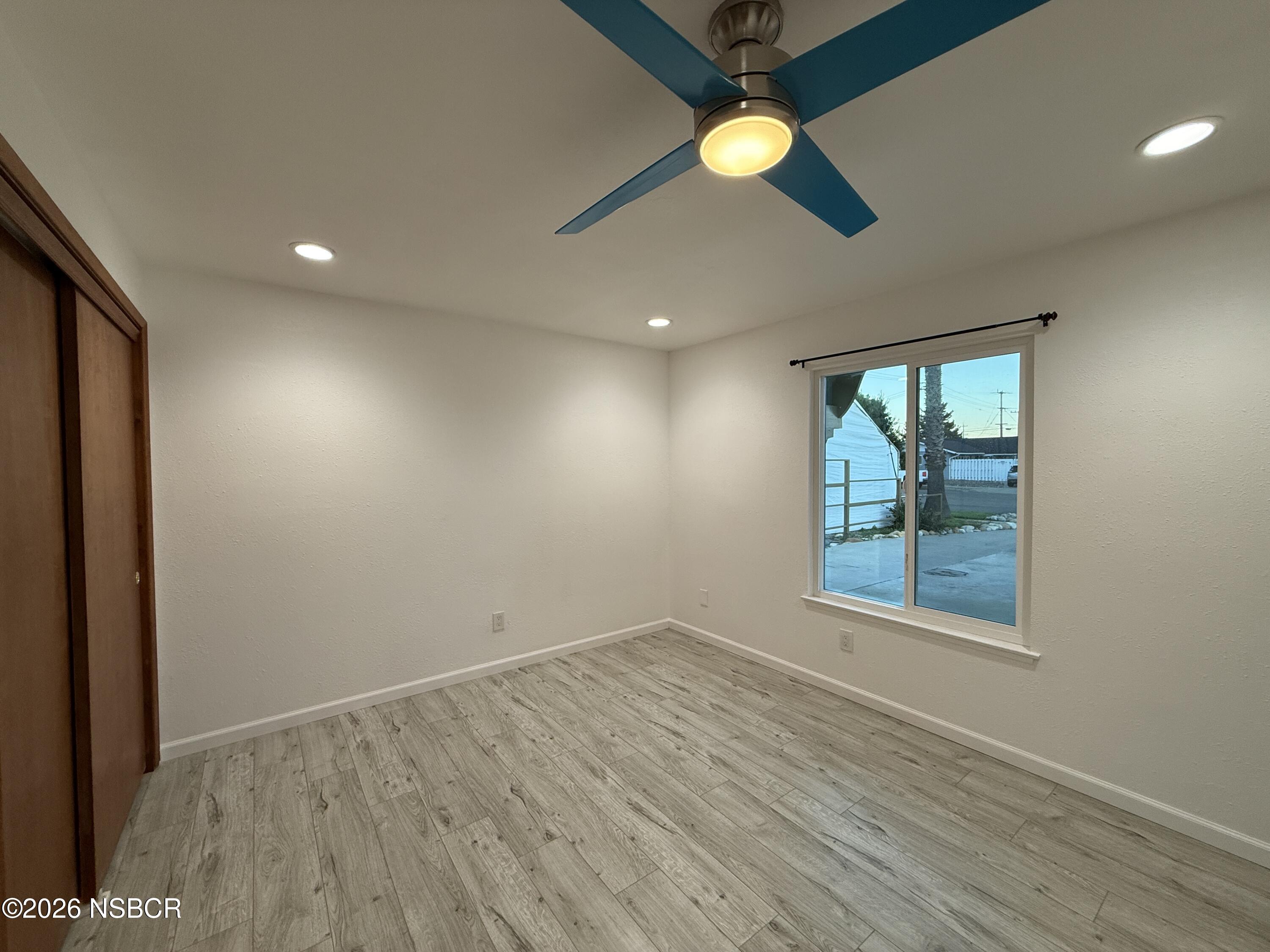 1408 West Walnut Avenue Lompoc, CA 93436 - Photo 13 of 27 wooden floor in an empty room with a window