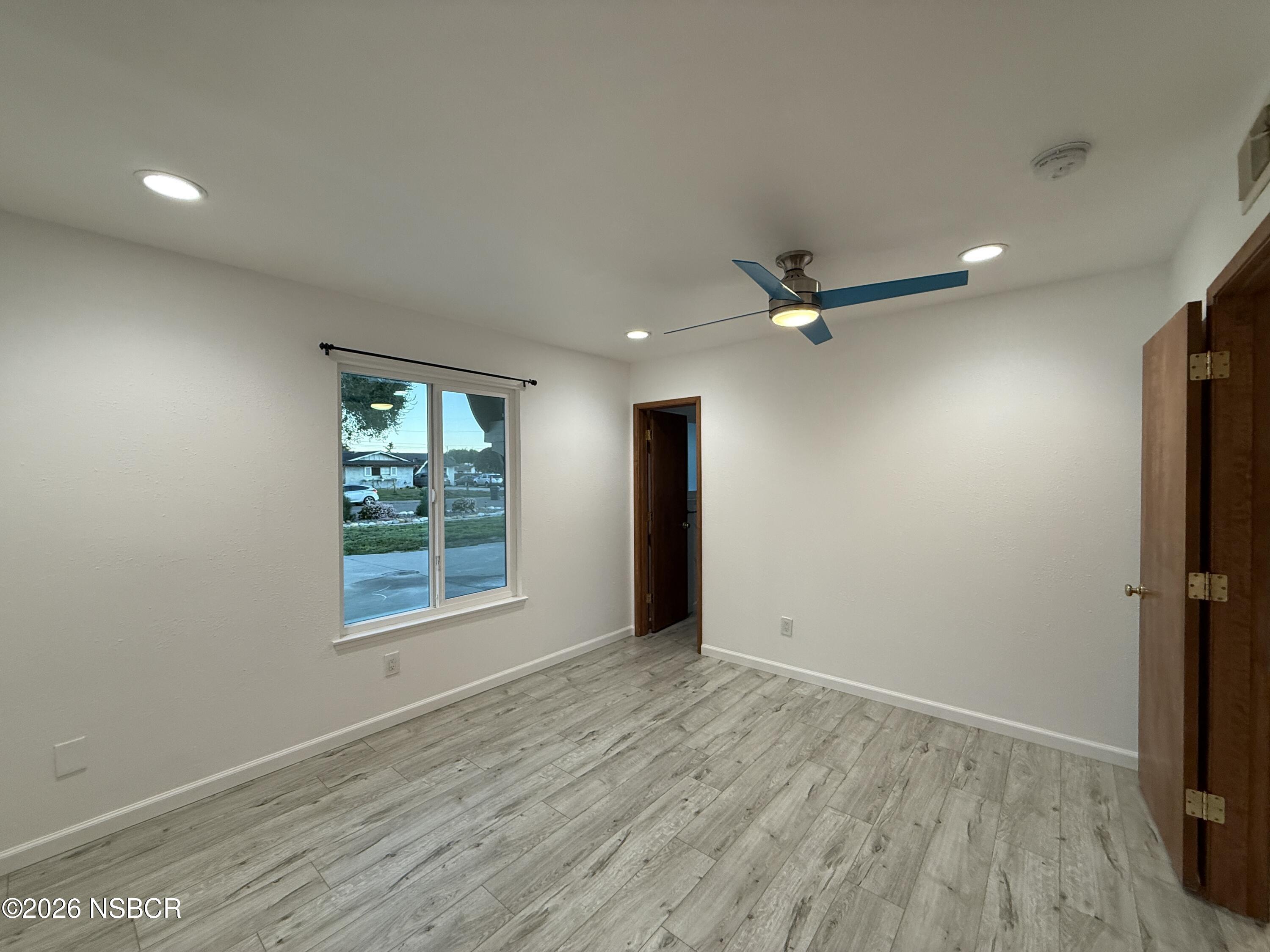 1408 West Walnut Avenue Lompoc, CA 93436 - Photo 14 of 27 wooden floor in an empty room with a window