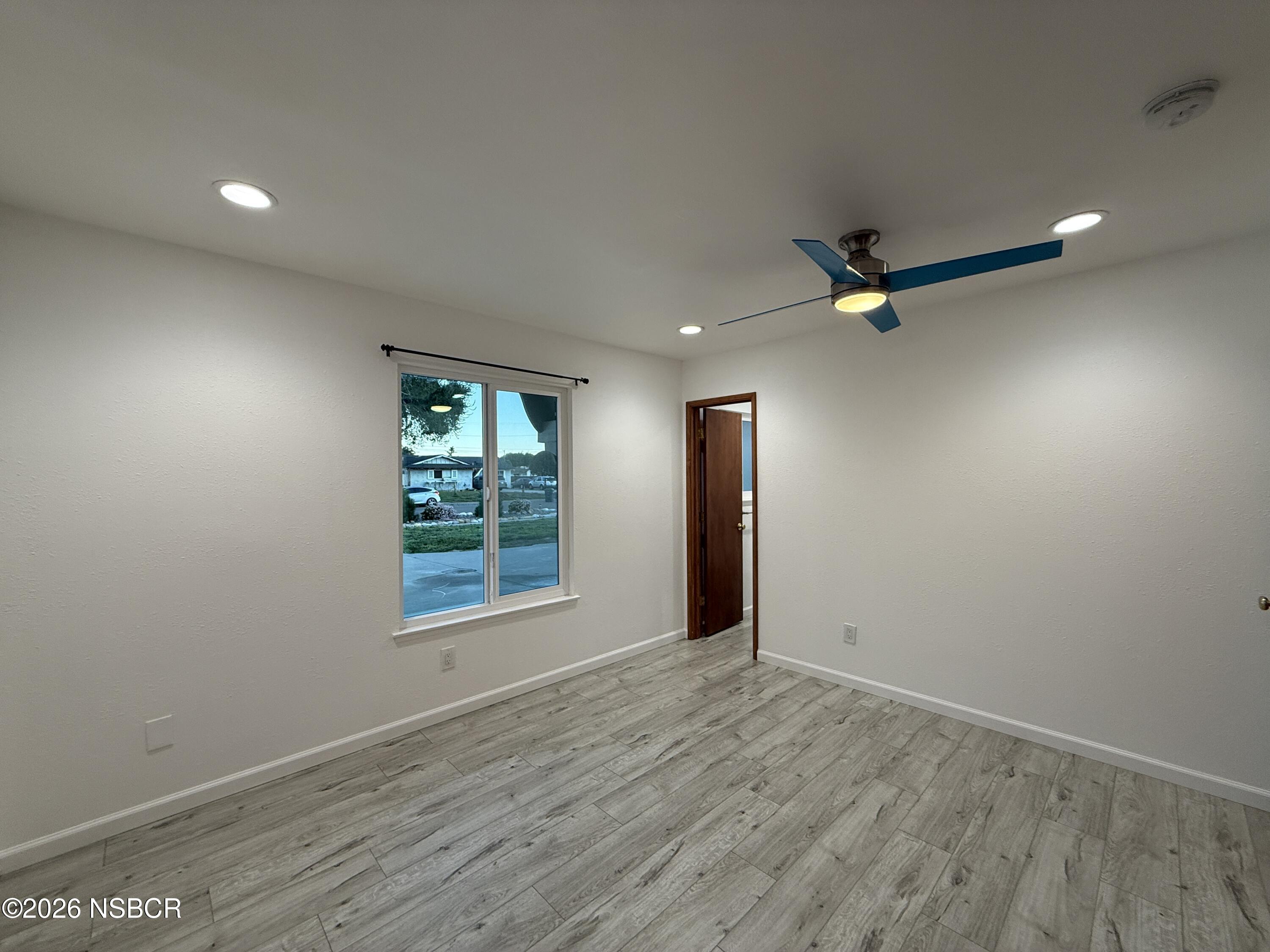 1408 West Walnut Avenue Lompoc, CA 93436 - Photo 15 of 27 wooden floor in an empty room with a window