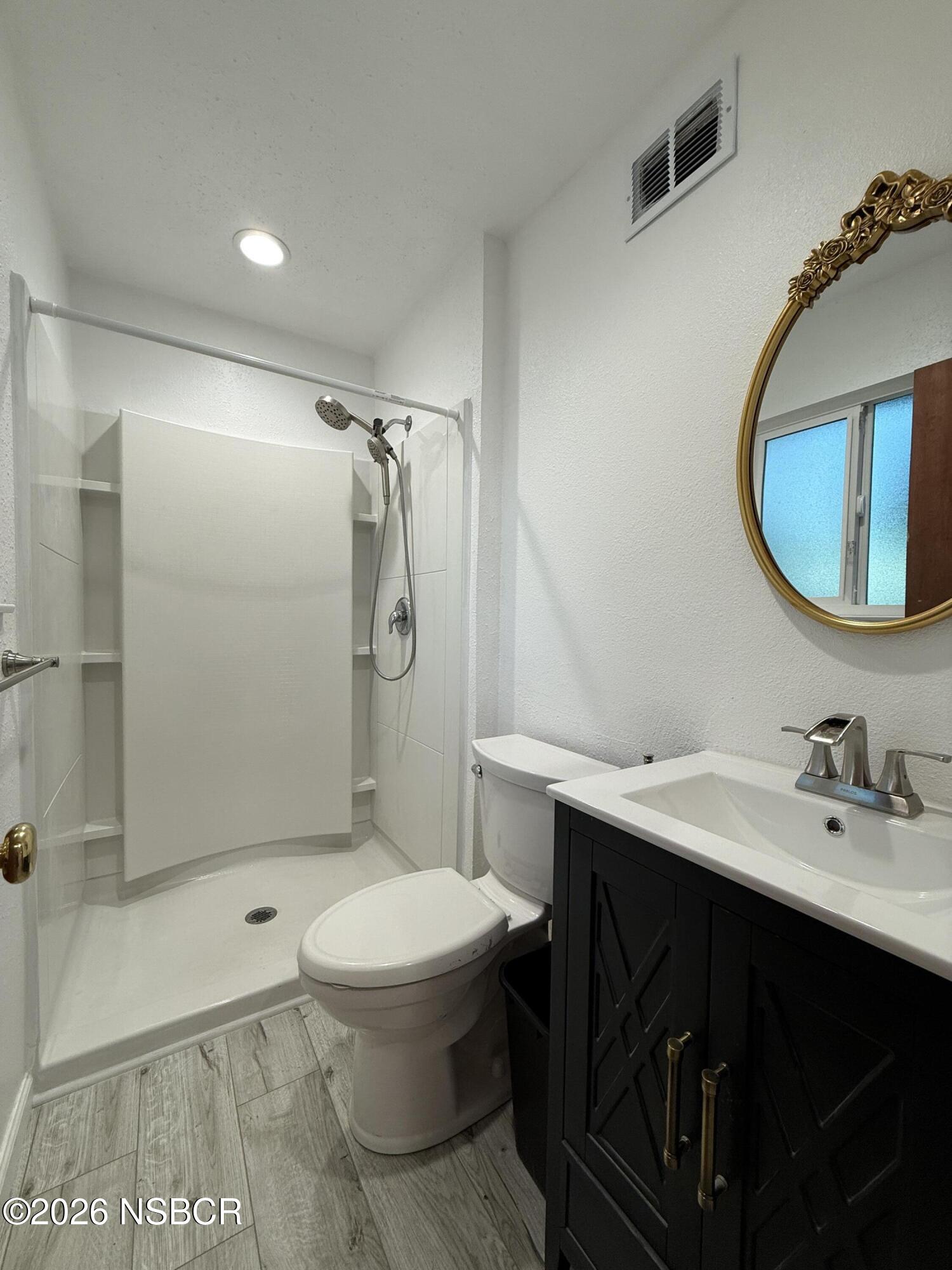 1408 West Walnut Avenue Lompoc, CA 93436 - Photo 16 of 27 a bathroom with a sink toilet and shower