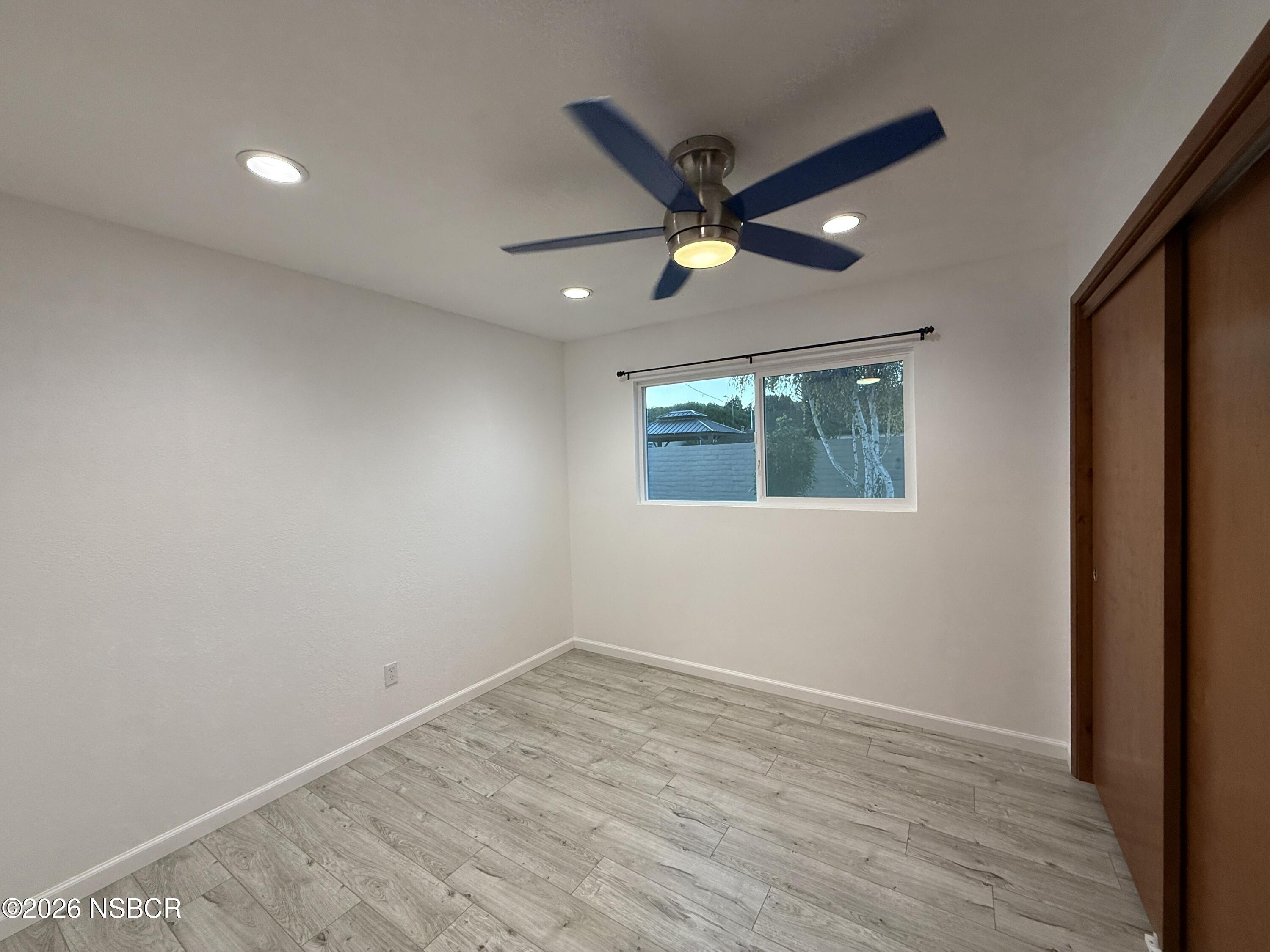1408 West Walnut Avenue Lompoc, CA 93436 - Photo 18 of 27 an empty room with a window and a ceiling fan