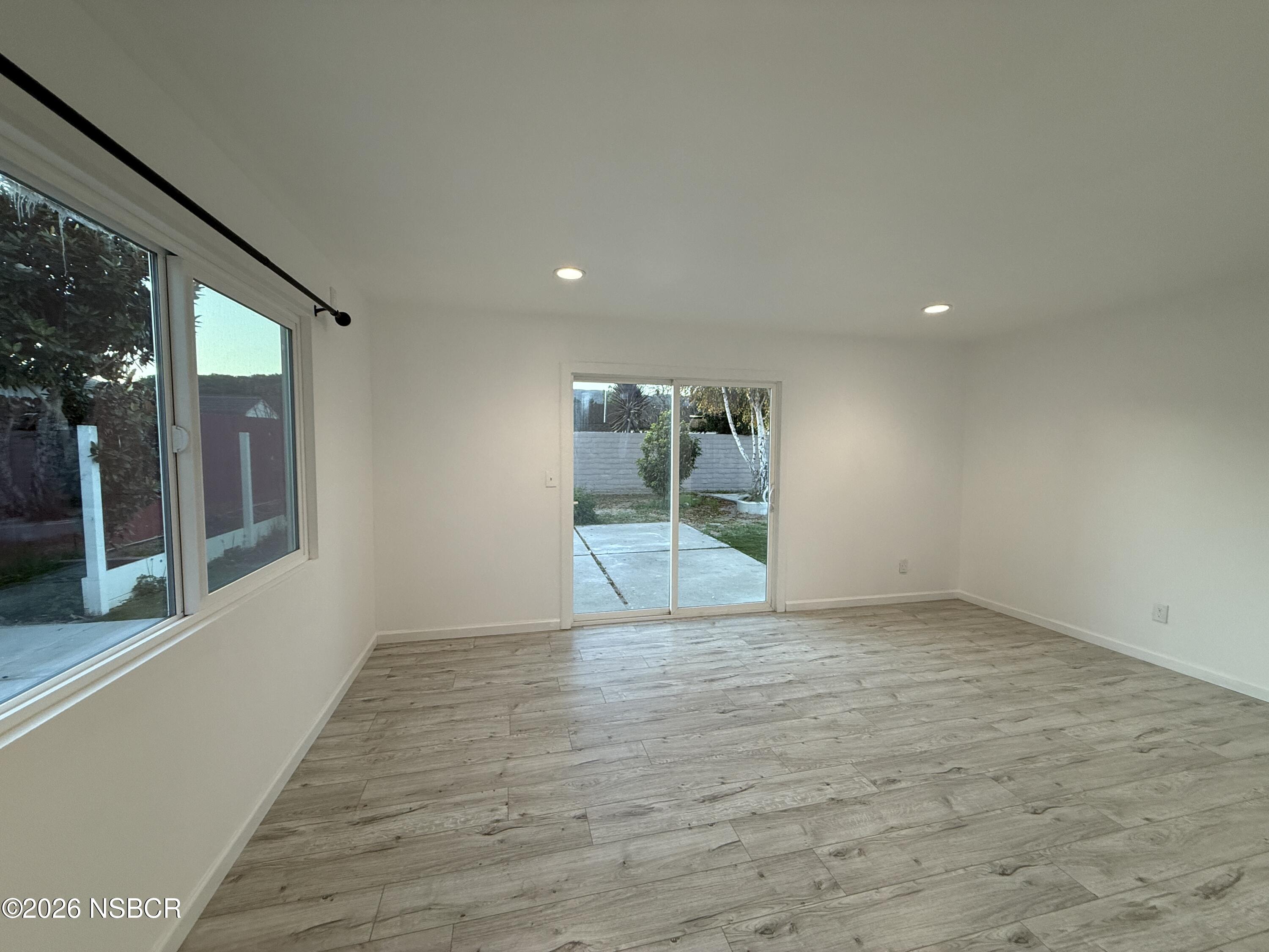 1408 West Walnut Avenue Lompoc, CA 93436 - Photo 21 of 27 a view of an empty room with glass door