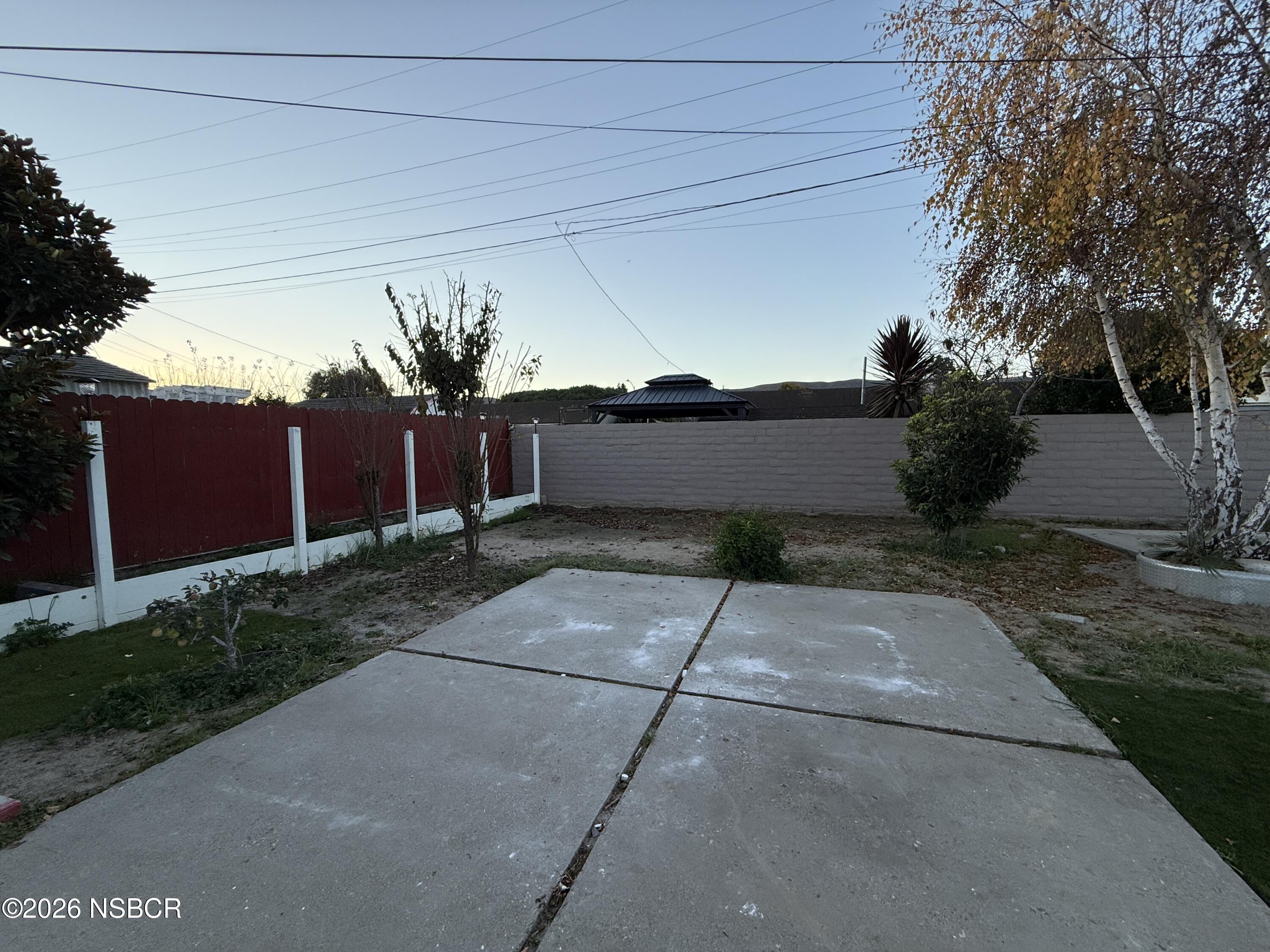 1408 West Walnut Avenue Lompoc, CA 93436 - Photo 23 of 27 a view of a yard and a house