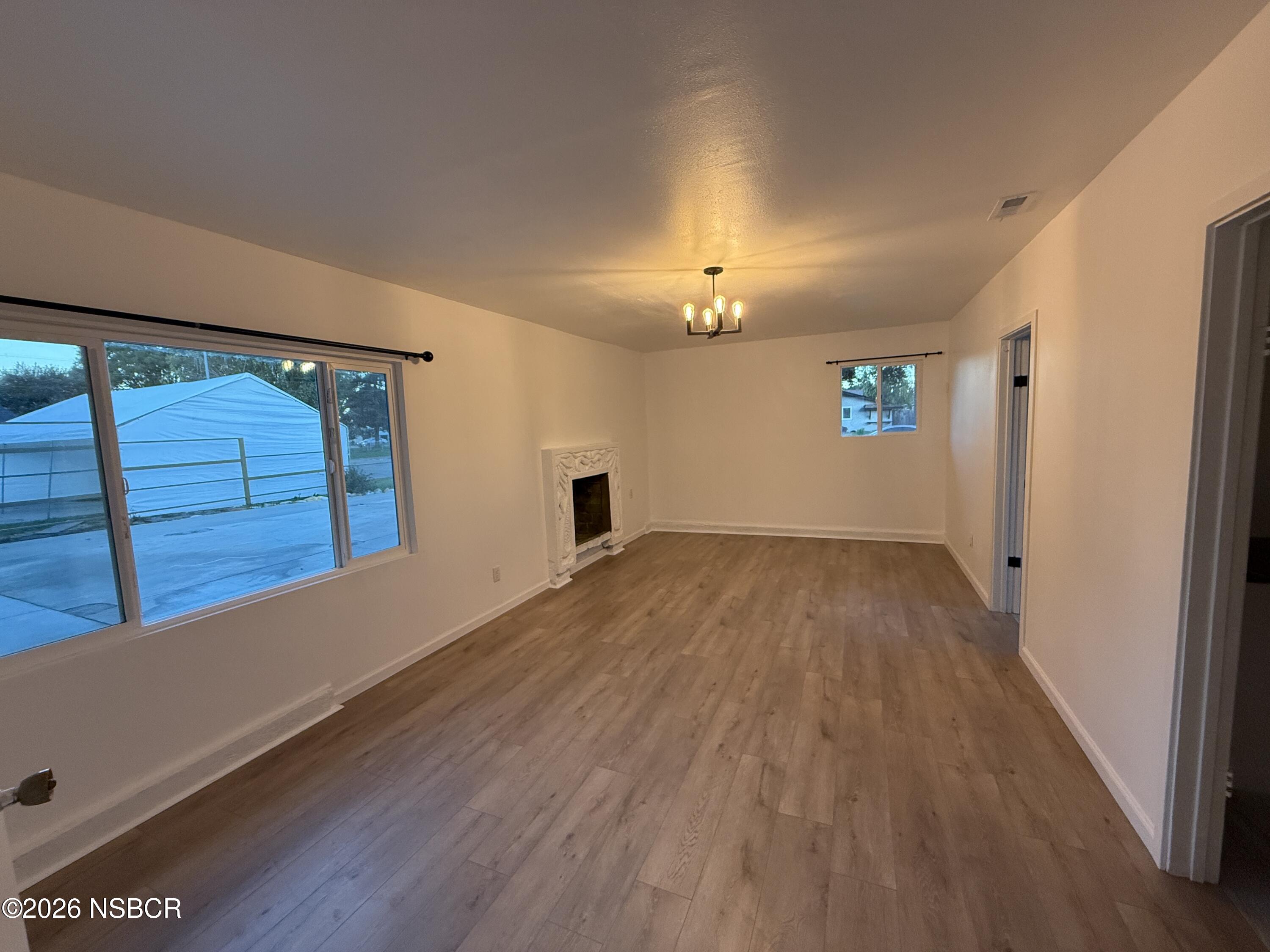 1408 West Walnut Avenue Lompoc, CA 93436 - Photo 7 of 27 a view of empty room with wooden floor