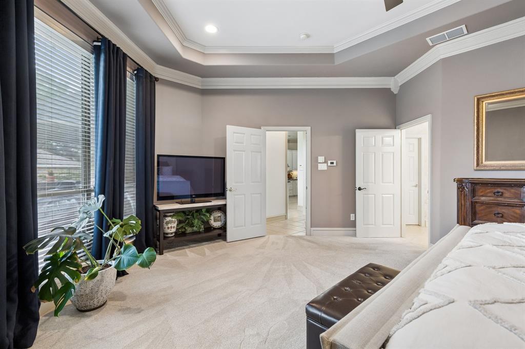 8517 Navigation Drive Rowlett, TX 75088 - Photo 20 of 39 a bedroom with a bed and a television