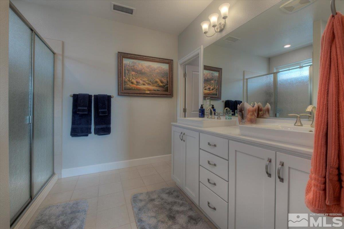 2049 Wind Ranch Road, Unit A Reno, NV 89521 - Photo 18 of 32 a bathroom with a double vanity sink and a mirror