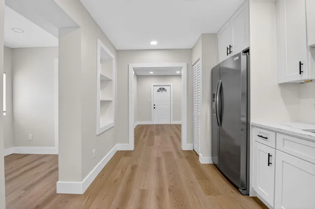 a view of hallway with wooden floor
