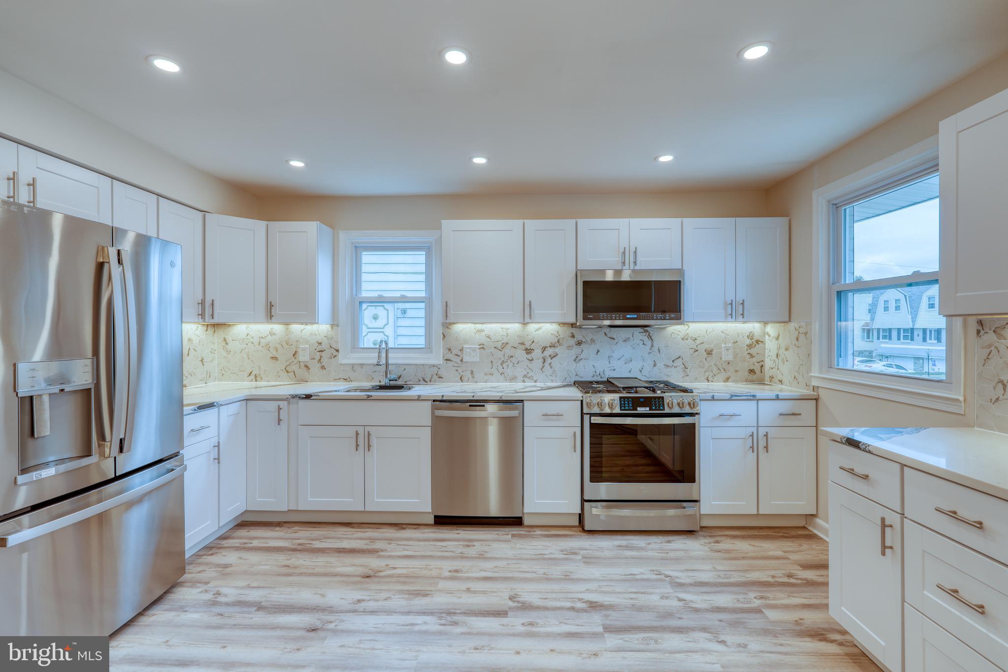 9939 Medway Road Philadelphia, PA 19115 - Photo 8 of 43 a kitchen with granite countertop stainless steel appliances and wooden cabinets
