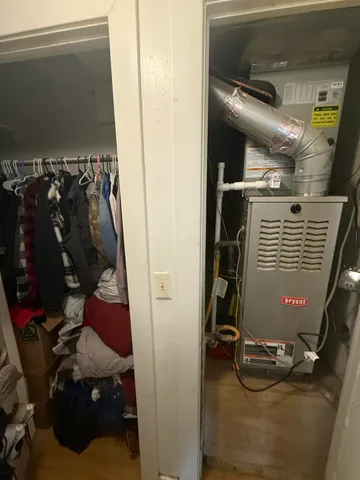 a view of a hallway with wooden floor and closet