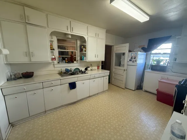 a kitchen with a refrigerator and washer