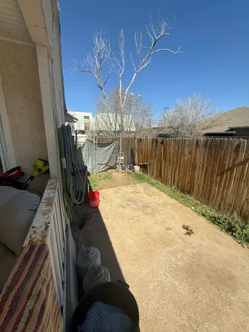 a view of a backyard with wooden fence