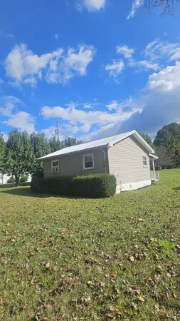 a view of house with yard