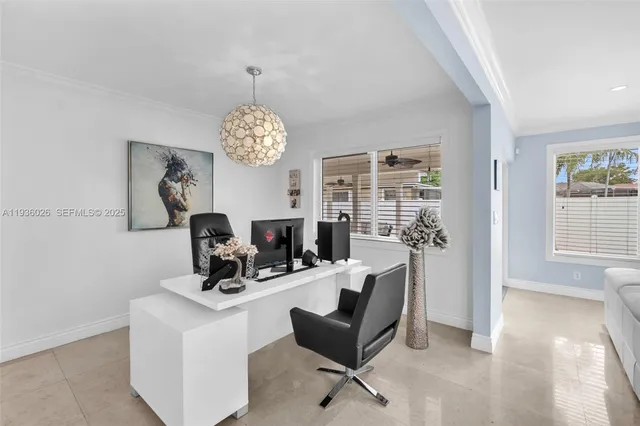 a view of a dining room with furniture and a chandelier