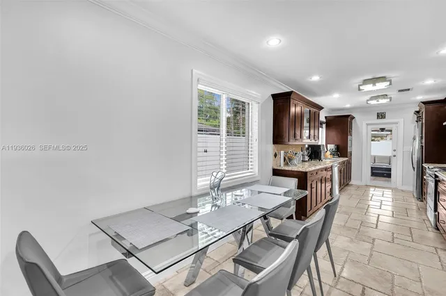 a large kitchen with a table and chairs in it