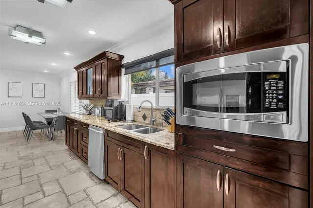a kitchen with stainless steel appliances granite countertop a sink and cabinets