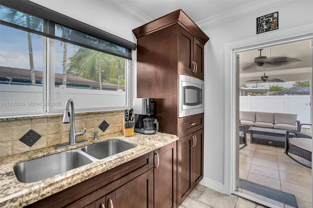 a kitchen with a sink refrigerator and cabinets