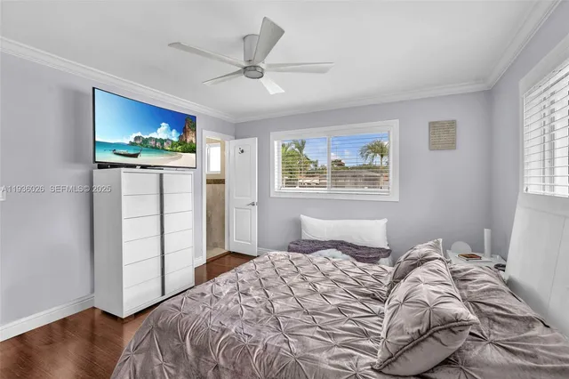 a bedroom with a large bed and a window