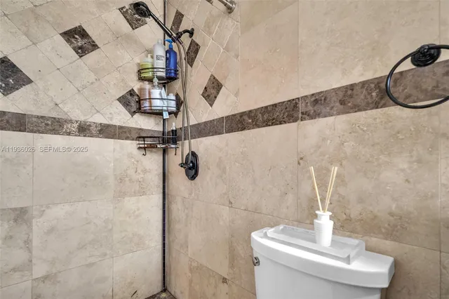 a bathroom with a sink mirror and shower