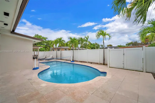 a building outdoor space with patio furniture and potted plants