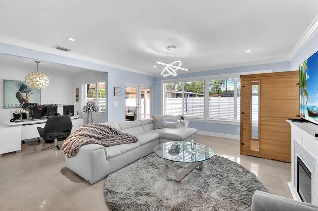 a bedroom with furniture and a large window