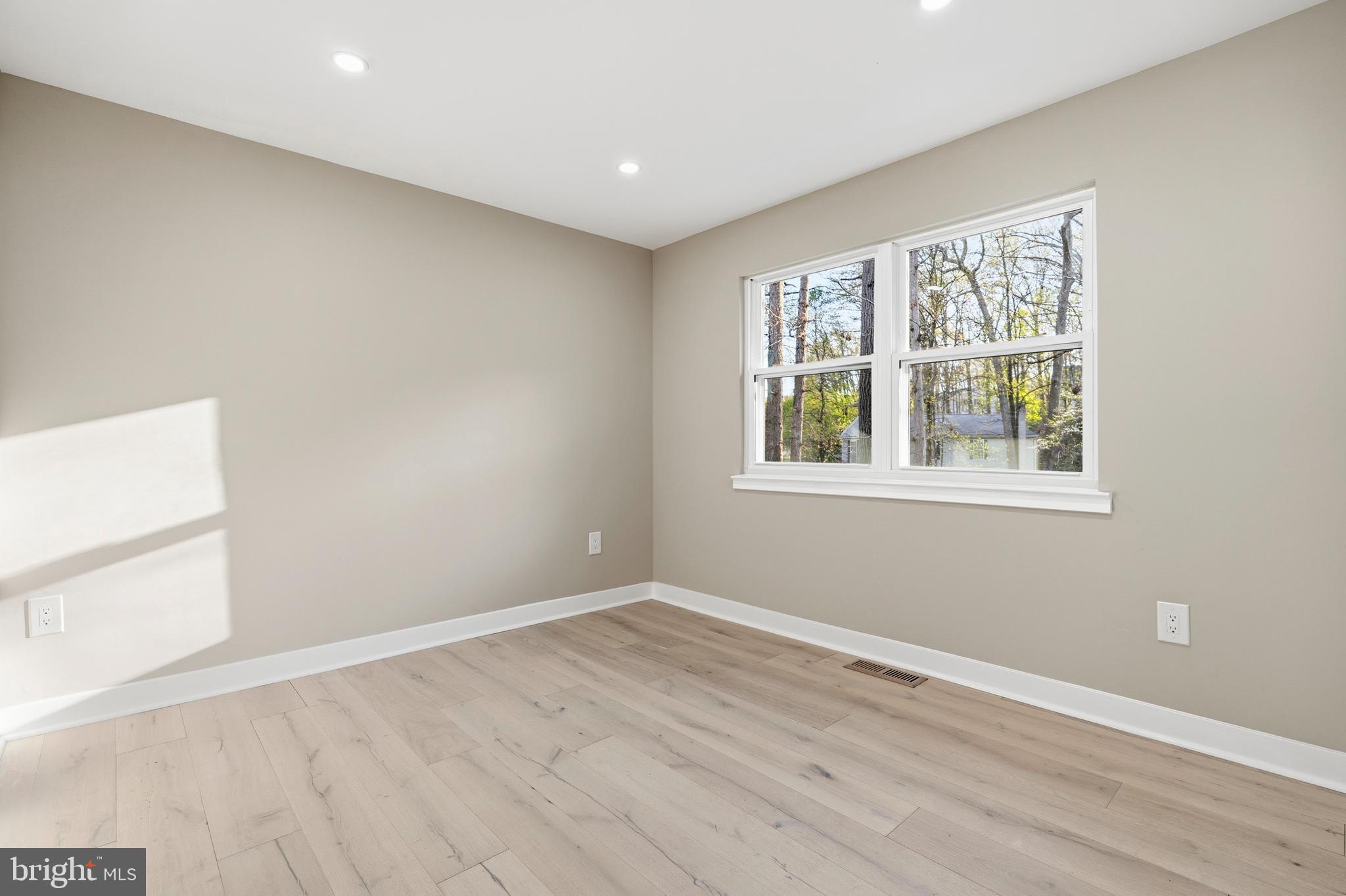 1840 Post Oak Trail Reston, VA 20191 - Photo 11 of 47 an empty room with wooden floor and windows