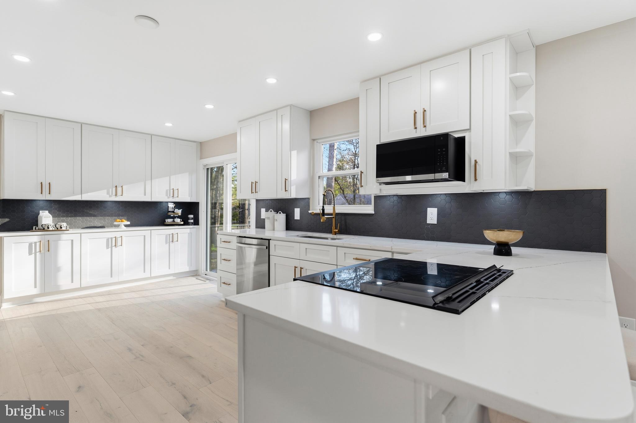 1840 Post Oak Trail Reston, VA 20191 - Photo 13 of 46 a kitchen with stainless steel appliances a stove a sink a microwave and cabinets