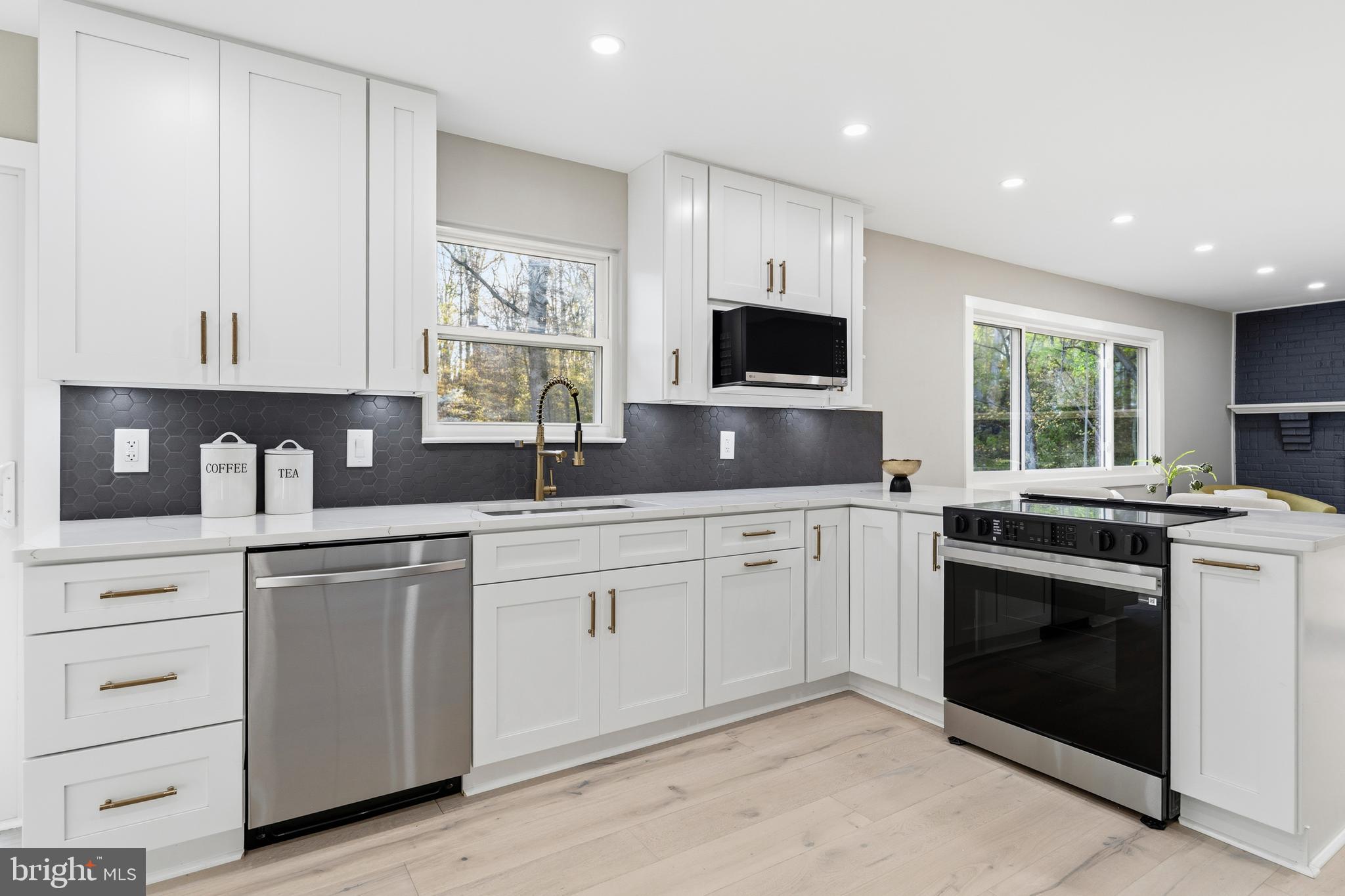 1840 Post Oak Trail Reston, VA 20191 - Photo 13 of 47 a kitchen with granite countertop white cabinets sink and stainless steel appliances