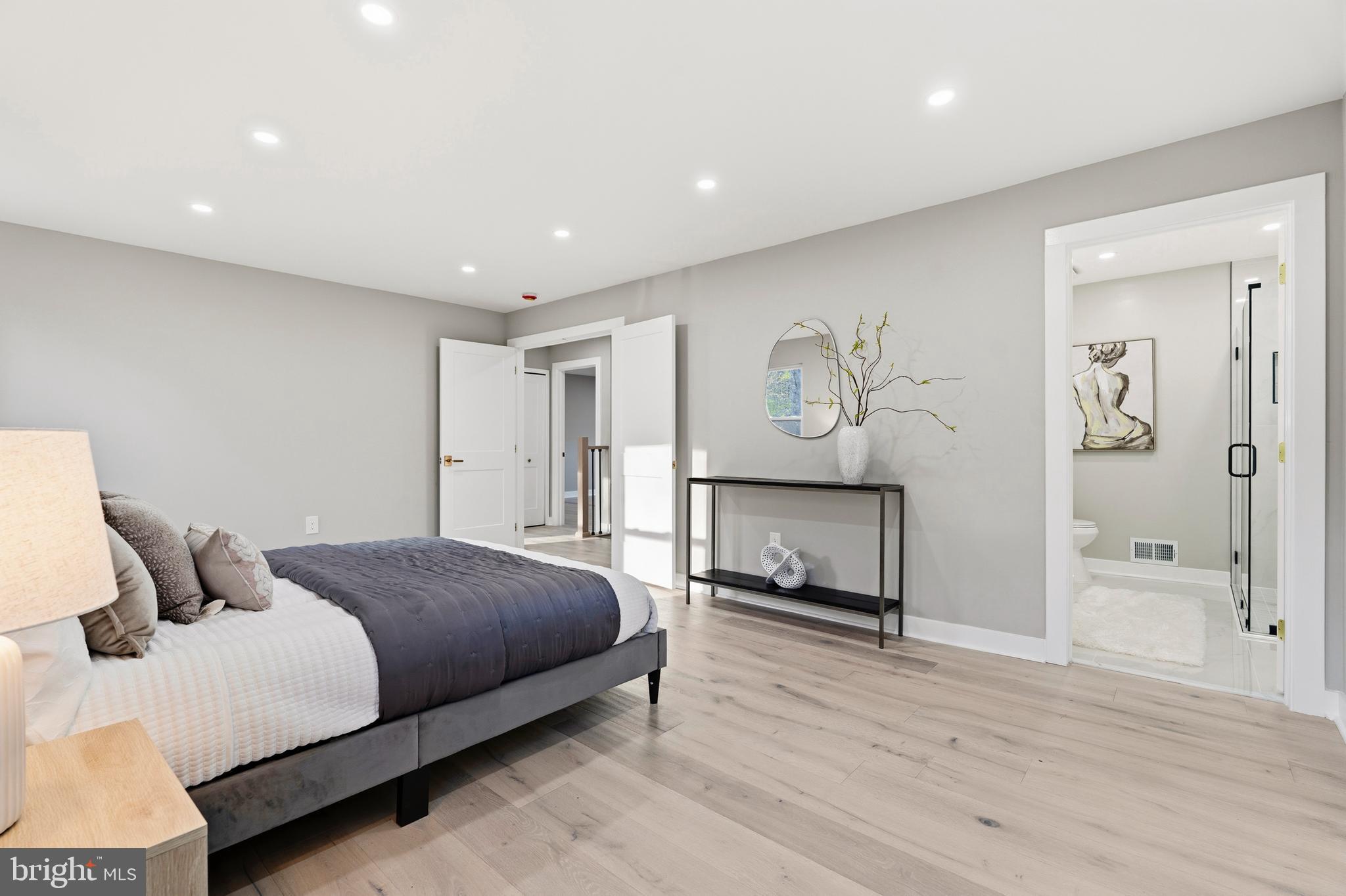 1840 Post Oak Trail Reston, VA 20191 - Photo 26 of 47 a bedroom with a large bed and a chandelier