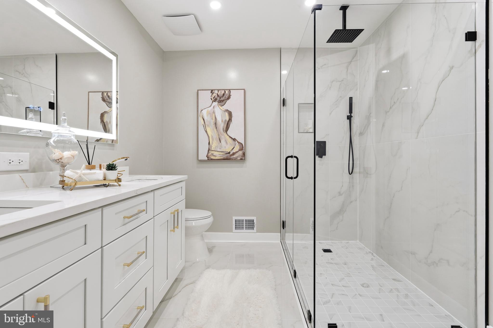 1840 Post Oak Trail Reston, VA 20191 - Photo 27 of 46 a spacious bathroom with a shower sink and mirror
