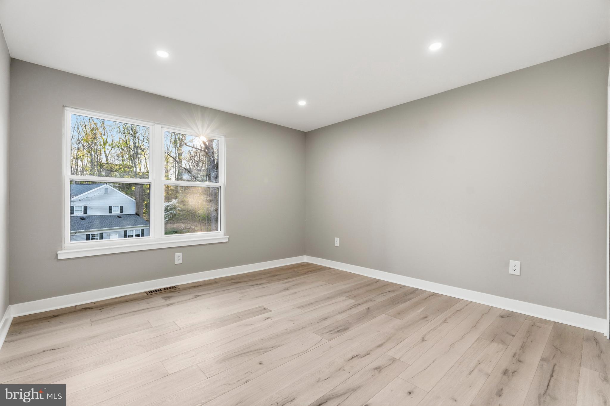 1840 Post Oak Trail Reston, VA 20191 - Photo 30 of 47 an empty room with wooden floor and windows