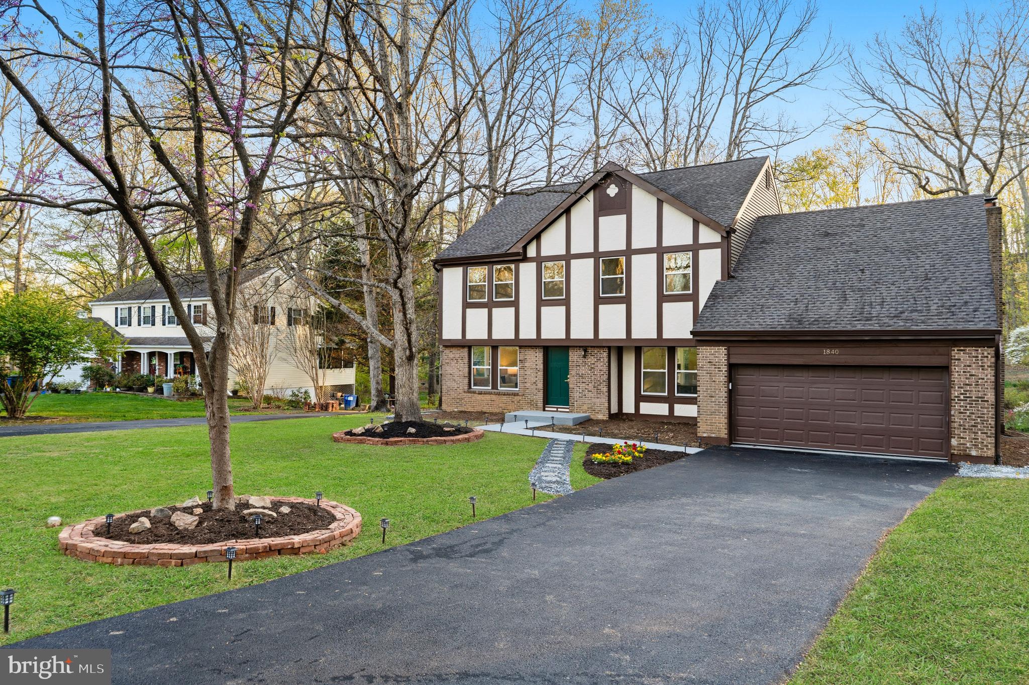1840 Post Oak Trail Reston, VA 20191 - Photo 3 of 47 a front view of a house with a garden and trees